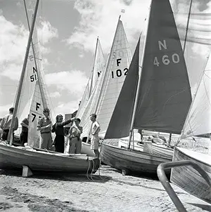 Sails: National 12 sailing dinghies on a Devon beach