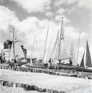 Sails: National 12 sailing dinghies on a Devon beach