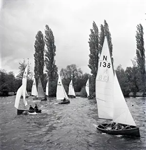 Sails: National 12 sailing dinghies on a Devon river