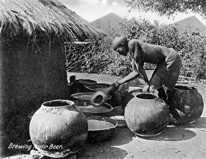 Pots: Native African Matabele man brewing beer
