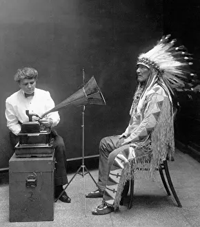 Ethnologist: Native American having his voice recorded. ?