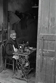 Stitching: A native craftsman at his sewing machine