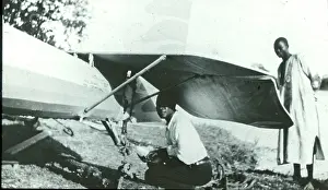 Leone: Natives repair tailplane (McCarthy Island)