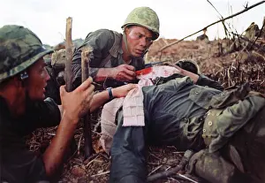 Quang: Navy corpsman provides medical support for a wounded
