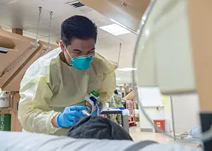 Sars: Navy Seaman Luis Librando prepares to take a patient's