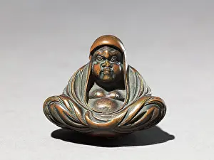 Meditating: Netsuke in the form of Daruma meditating
