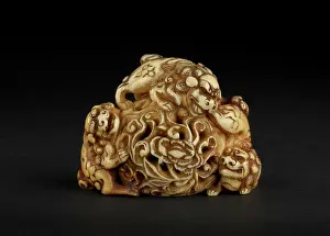 Shishi: Netsuke in the form of three shishi playing on a rock