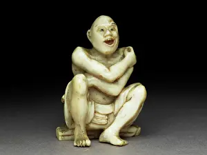 Legge: Netsuke - man sitting on a mat made of twigs washing himself