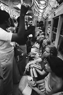 Straphangers: New York Subway. Passengers commuting on ?