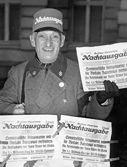 Prevent: Newspaperman with the late-night edition of
