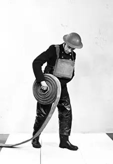 Instructional: NFS firefighter rolling out fire hose, WW2
