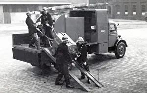 Tenders: NFS heavy unit crew removing mobile pump by ramp