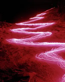 Aerials: Night Abstract Strobe Pattern of Skiers Skiing Downhill