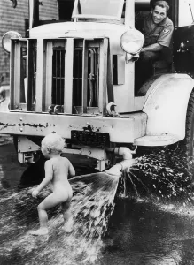 Sprinkler: A nudie beneath the sprinkler