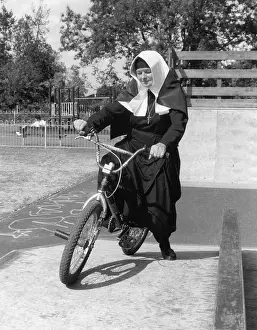 Nun on a bicycle in a playground