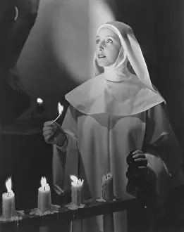 Matchstick: Nun lighting candles in church