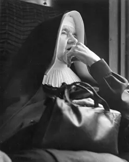 Thoughtful: Nun sitting looking thoughtful