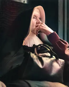 Thoughtful: Nun sitting looking thoughtful
