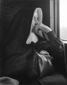 Thoughtful: Nun sitting by a window