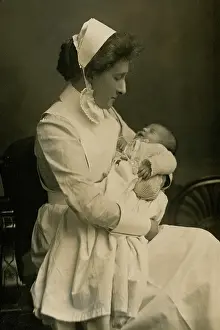 Caring: Nurse cradling baby