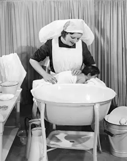 Pitchers: Nurse dries baby after bath