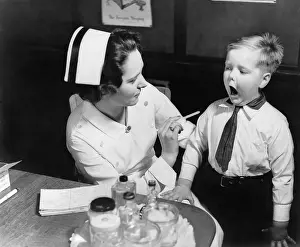 Depressor: A nurse examining the teeth of a boy in ?