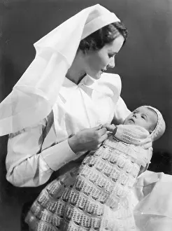 Crocheted: Nurse holding baby