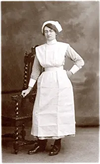 The Royal College Of Nursing: Nurse Standing by Chair with Hand on hip