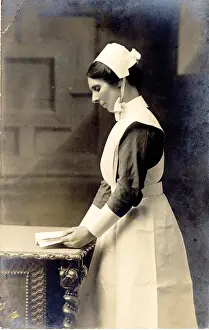 The Royal College Of Nursing: Nurse Standing at Table with Book