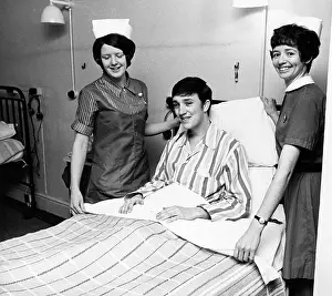 Pyjamas: Two nurses with patient in hospital ward