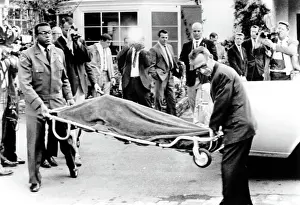 Estranged: Officials carrying the body of Mickey Rooney's ?