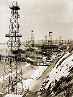 Hydrocarbons: Oil well derricks on the beach along the ?