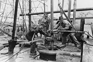 Wrenches: Oil rig workers, called roughnecks, at work, ?