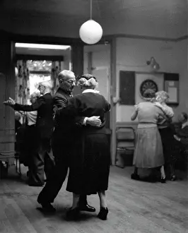Comprised: Old-aged couples dancing in a club