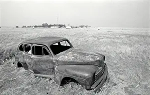 Rusted: An old car abandoned in a field during the drought