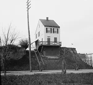 Precariously: Old house, precariously perched above street ?