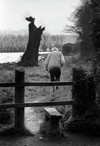 Stooped: Old man on footpath, Suffolk, England