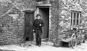 Stonemason: Old man outside house