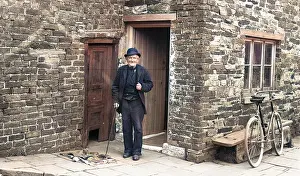 Stonemason: Old man outside house