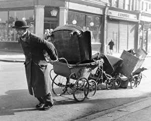 Jenner: Old man pulling prams, Balham, SW London