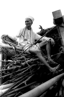 Stocktrek Images: An old man sits in the back of a trucks a convoy