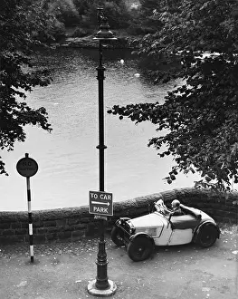 Lampost: Old Man in a small car by the River Dee - Chester