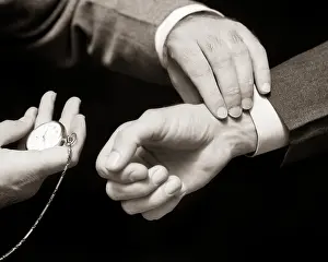 Fingertips: Old-Time Doctor's Hands Taking Male Pulse with