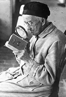 Microfilm: Old woman reading a book