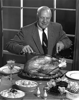 Pausing: Older Man Carving a Turkey