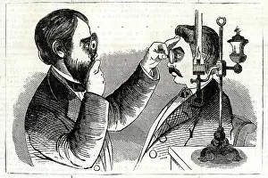 Examination: Optician examining a patient's eyes