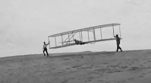 Prone: Orville Wright and glider, Kitty Hawk