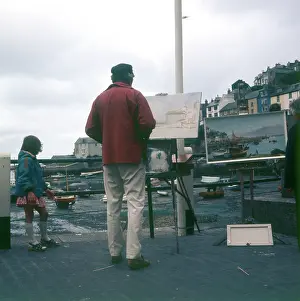 Brixham: Outdoor painter working on Brixham Harbour, Devon