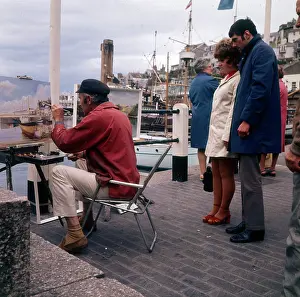 Brixham: Outdoor painter working on Brixham Harbour, Devon