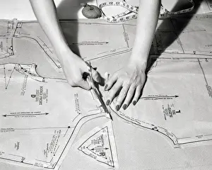 Overhead View of Woman Using Scissors Cutting